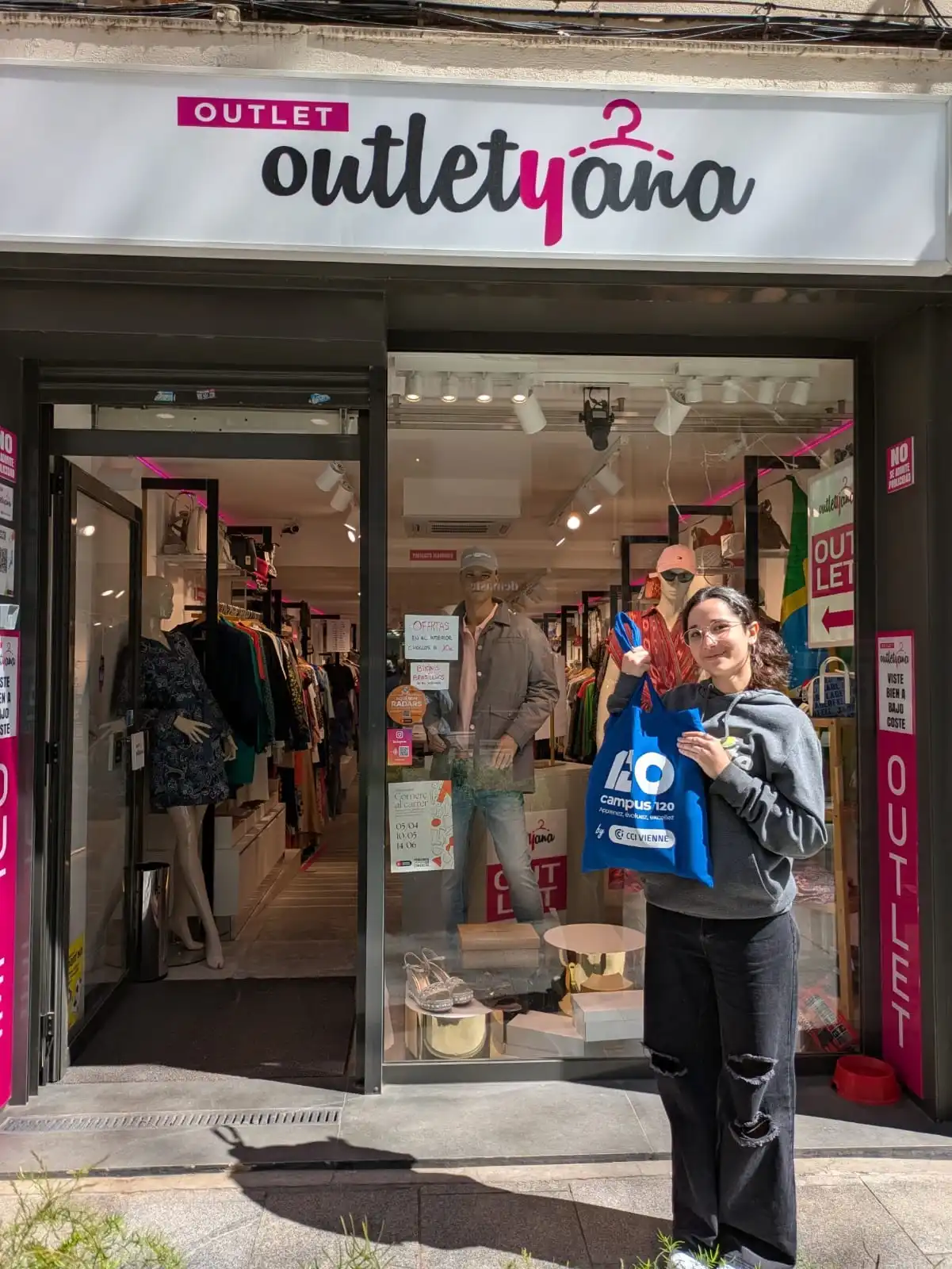 Erasmus+ retail student in front of her host store.
